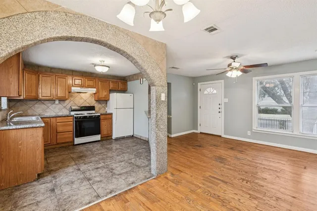 a view of a kitchen with a sink and a kitchen view