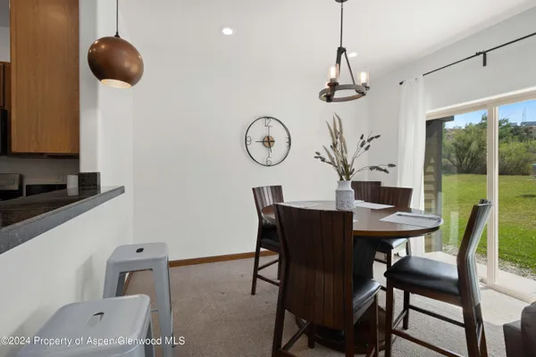 a view of a dining room with furniture window and outside view