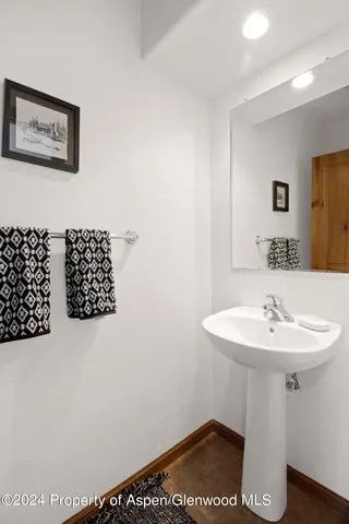a bathroom with a sink a mirror and a window