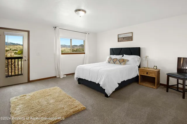 a bedroom with a bed and night stand