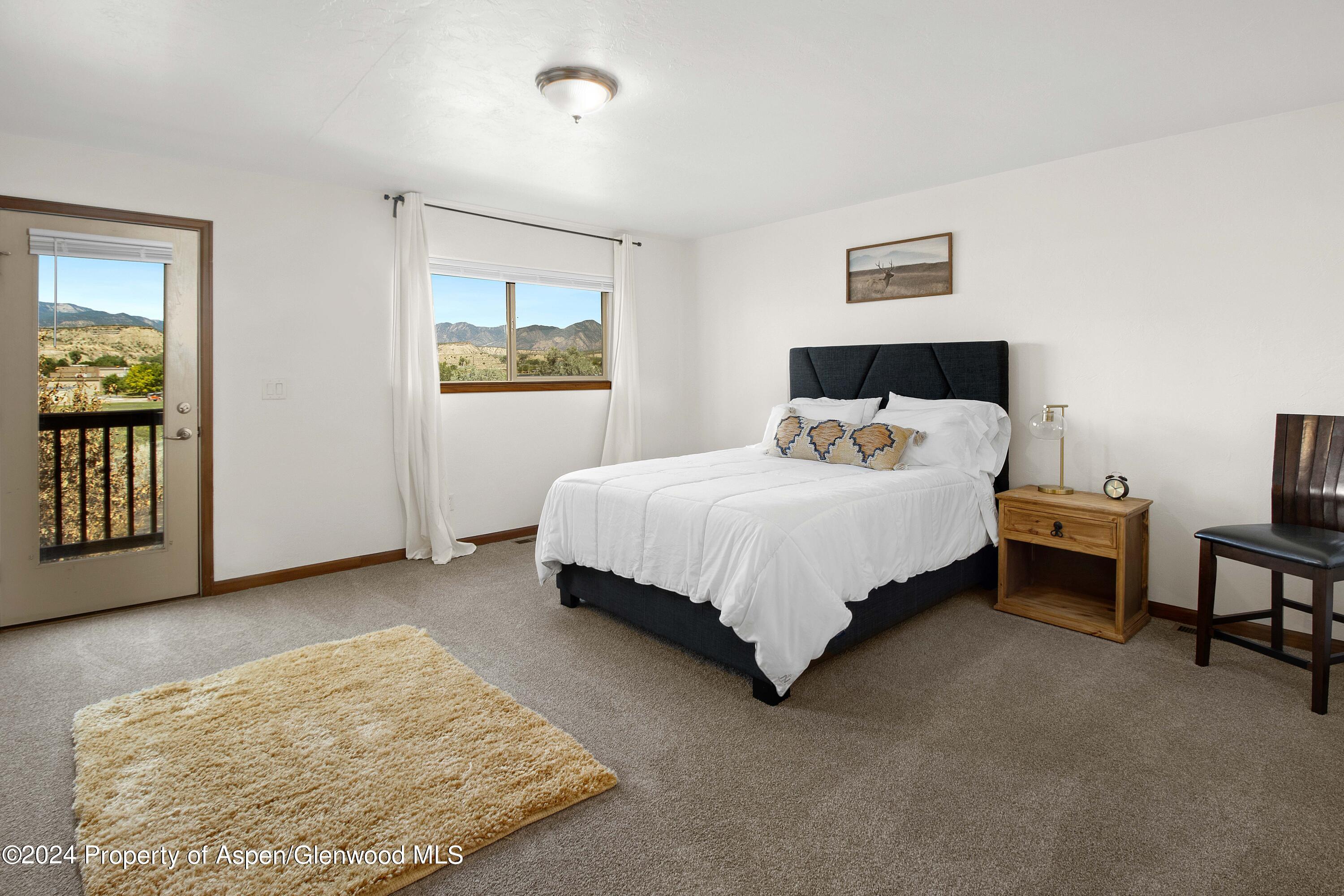 Rifle Proper Rifle, CO 81650 - Photo 16 of 23 a bedroom with a bed and night stand