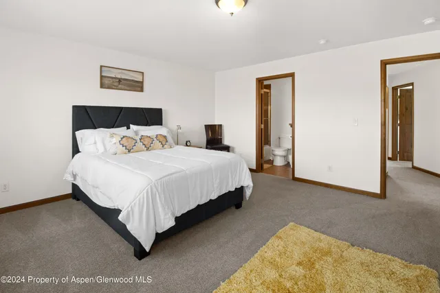 a bedroom with bed and window