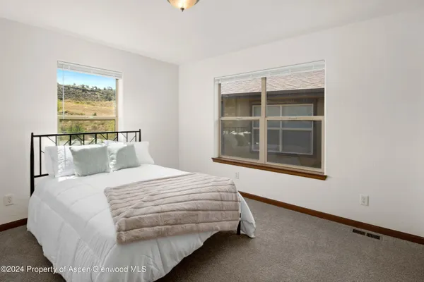 a bedroom with a bed and window