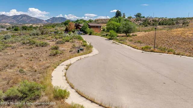 a view of a house with a yard and mountain view