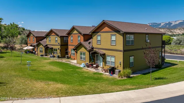 a front view of house with yard and green space