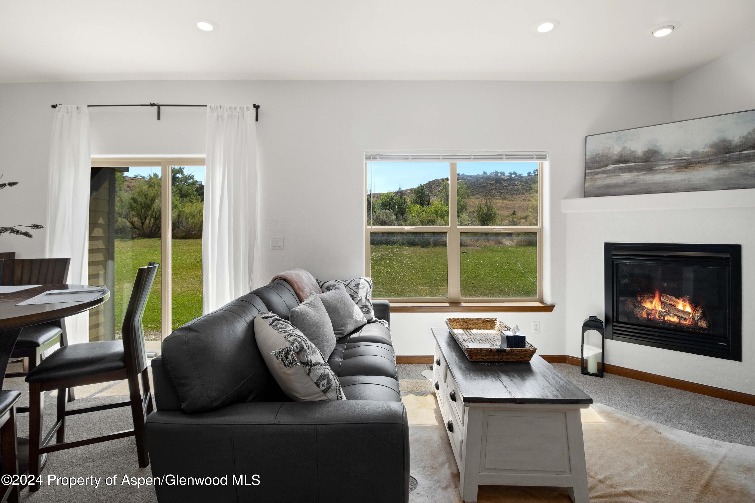 Rifle Proper Rifle, CO 81650 - Photo 10 of 23 a living room with furniture a fireplace and a large window