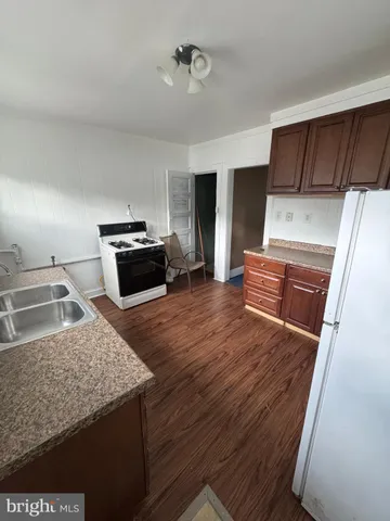 a kitchen with granite countertop a stove and a refrigerator