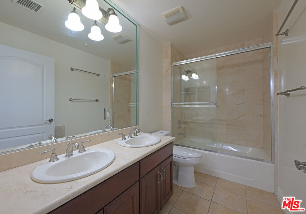 8555 Cashio Street, Unit PH4 Los Angeles, CA 90035 - Photo 11 of 43 a bathroom with a sink a toilet and shower
