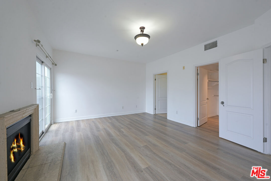 8555 Cashio Street, Unit PH4 Los Angeles, CA 90035 - Photo 15 of 43 a view of livingroom with hardwood floor and a fireplace