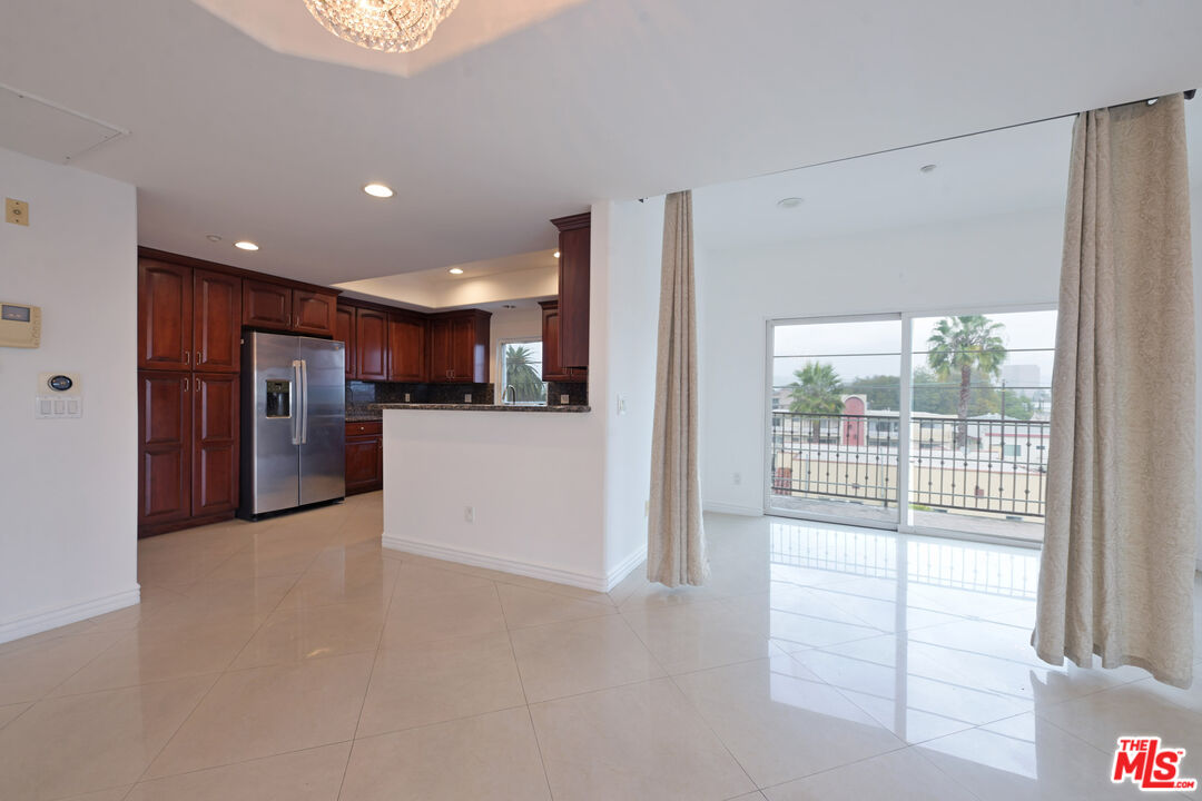 8555 Cashio Street, Unit PH4 Los Angeles, CA 90035 - Photo 23 of 43 a view of a kitchen with refrigerator and a sink