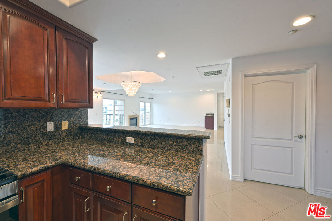 8555 Cashio Street, Unit PH4 Los Angeles, CA 90035 - Photo 28 of 43 a kitchen with granite countertop a sink and cabinets