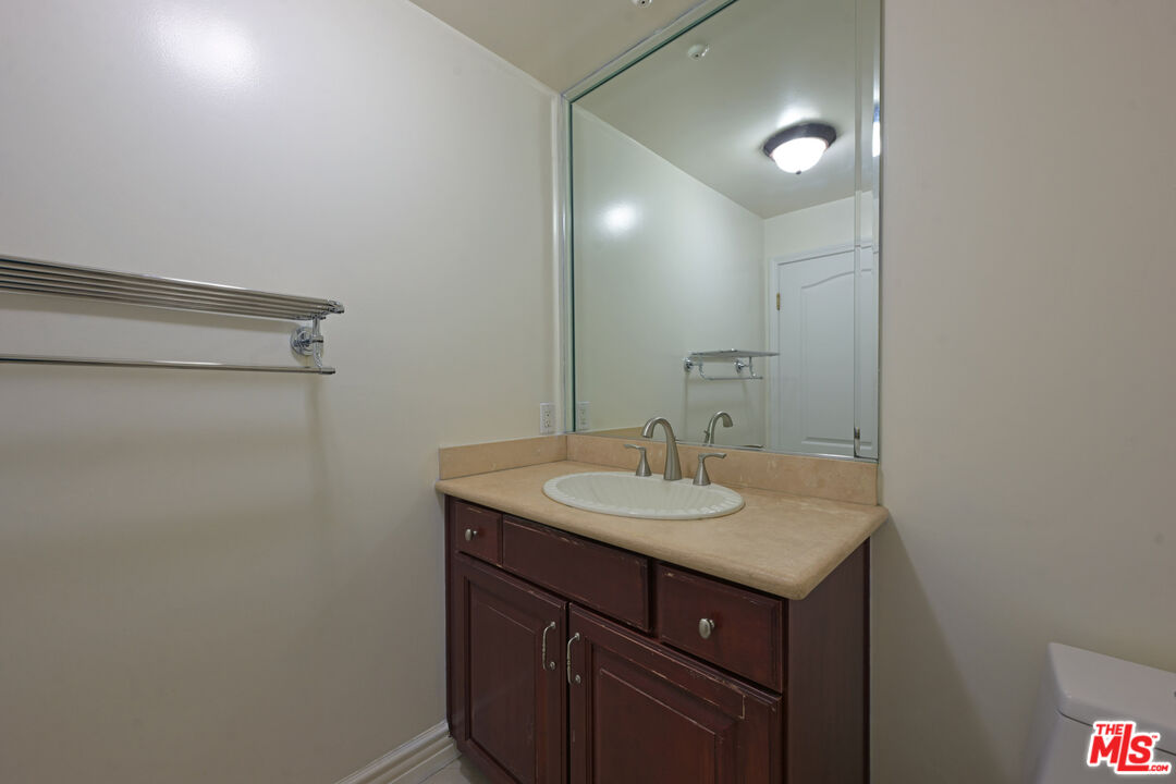8555 Cashio Street, Unit PH4 Los Angeles, CA 90035 - Photo 29 of 43 a bathroom with a sink and a mirror