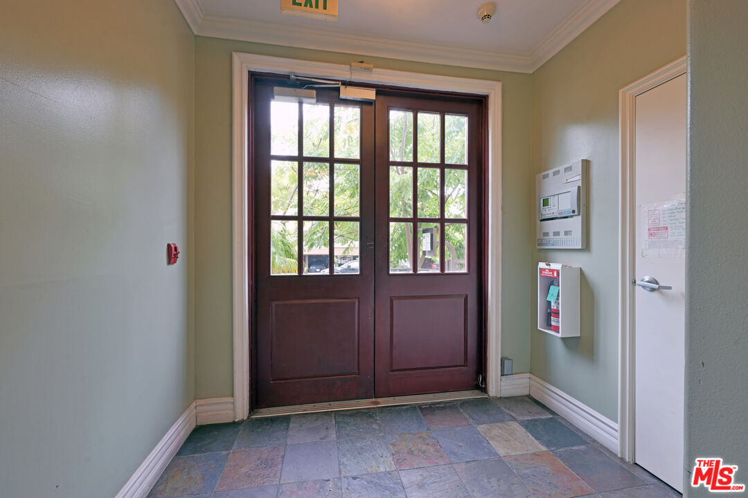 8555 Cashio Street, Unit PH4 Los Angeles, CA 90035 - Photo 30 of 43 an empty room with entrance and windows