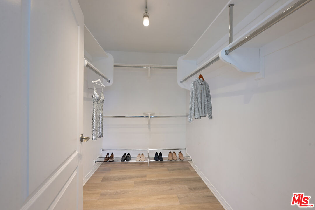 8555 Cashio Street, Unit PH4 Los Angeles, CA 90035 - Photo 34 of 43 a view of a room with wooden floor and fan