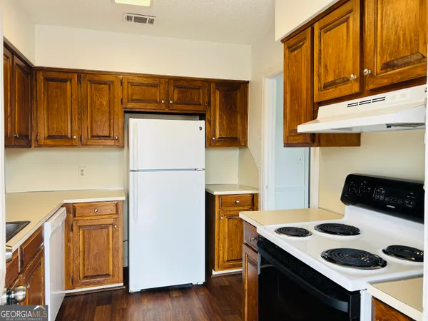 a kitchen with stainless steel appliances granite countertop a sink and cabinets