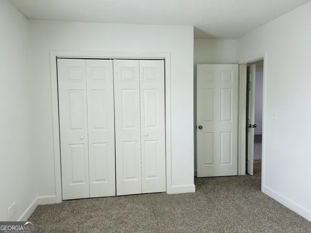 a view of a brick house with a yard