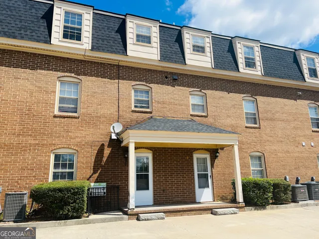 a sign that is sitting in front of flowers