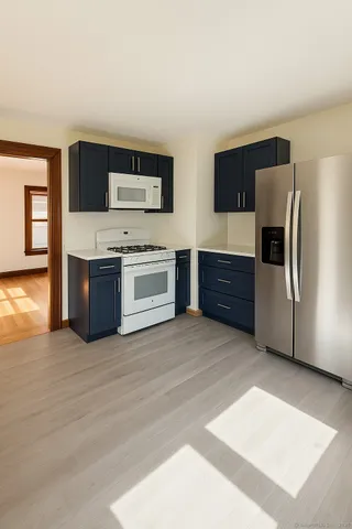 a kitchen with stainless steel appliances wooden cabinets and a refrigerator
