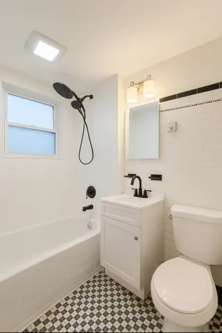 a bathroom with a toilet a sink and a bathtub
