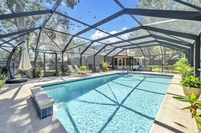 an aerial view of residential houses with outdoor space and trees