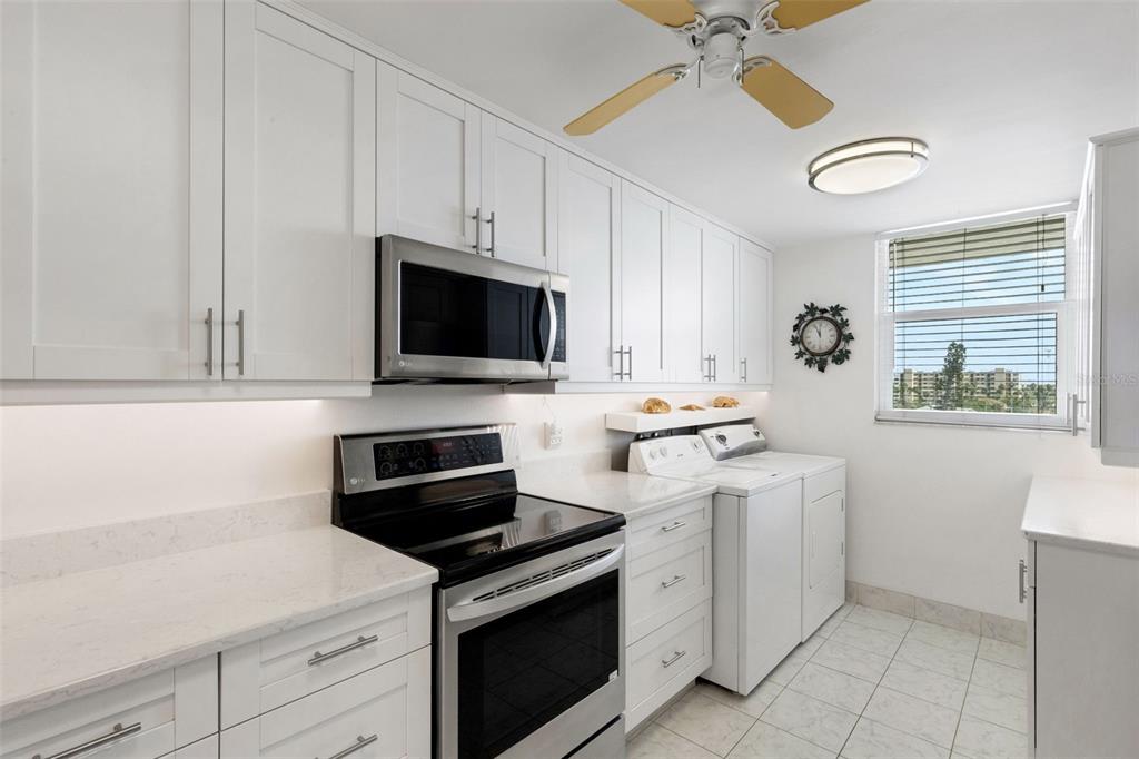14900 Gulf Boulevard, Unit 410 Madeira Beach, FL 33708 - Photo 7 of 76 a kitchen with a stove and a microwave
