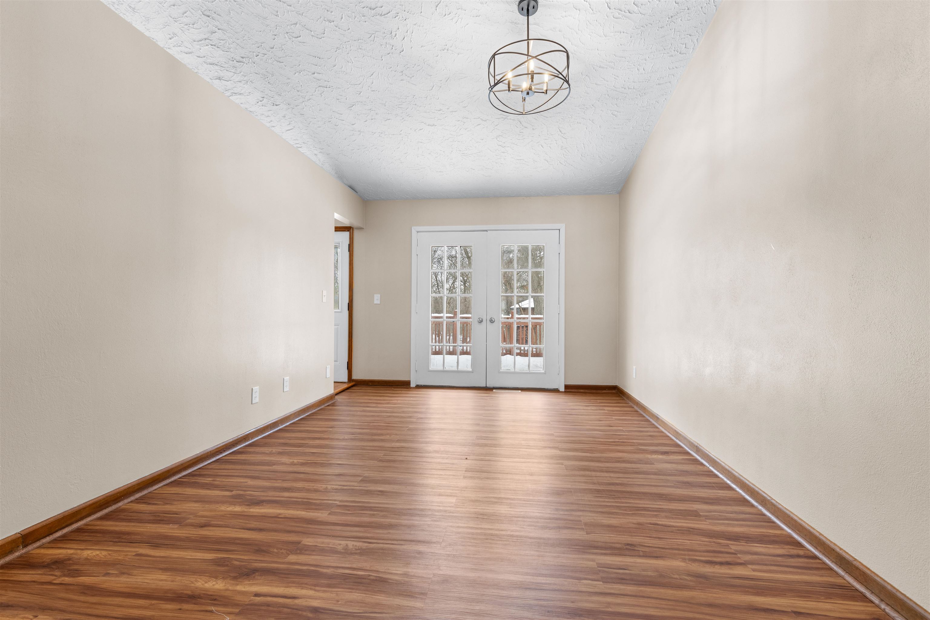 11738 Southgate Road Roscoe, IL 61073 - Photo 12 of 27 a view of an empty room with a window and wooden floor
