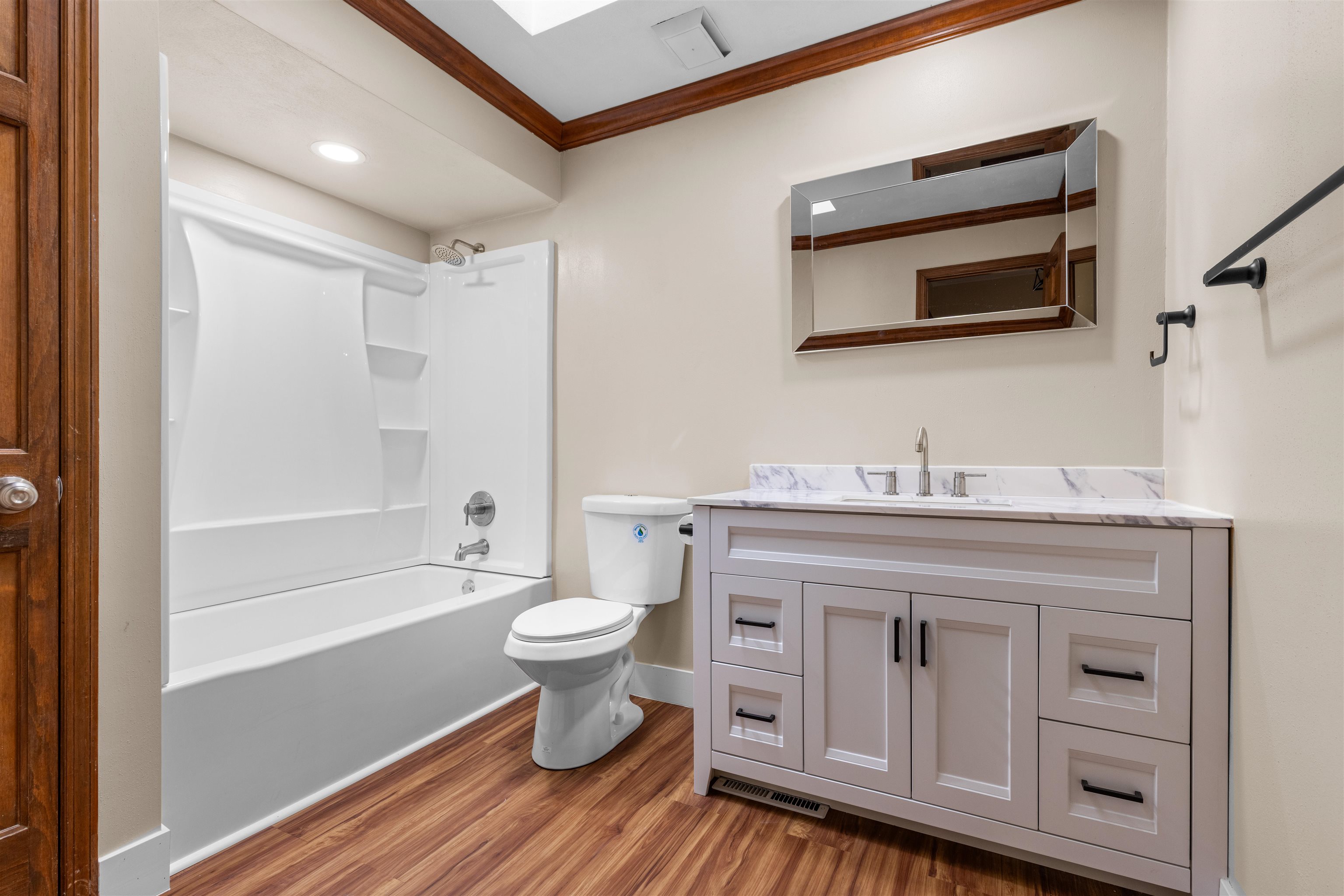 11738 Southgate Road Roscoe, IL 61073 - Photo 17 of 27 a bathroom with a toilet a sink a mirror a bathtub and shower