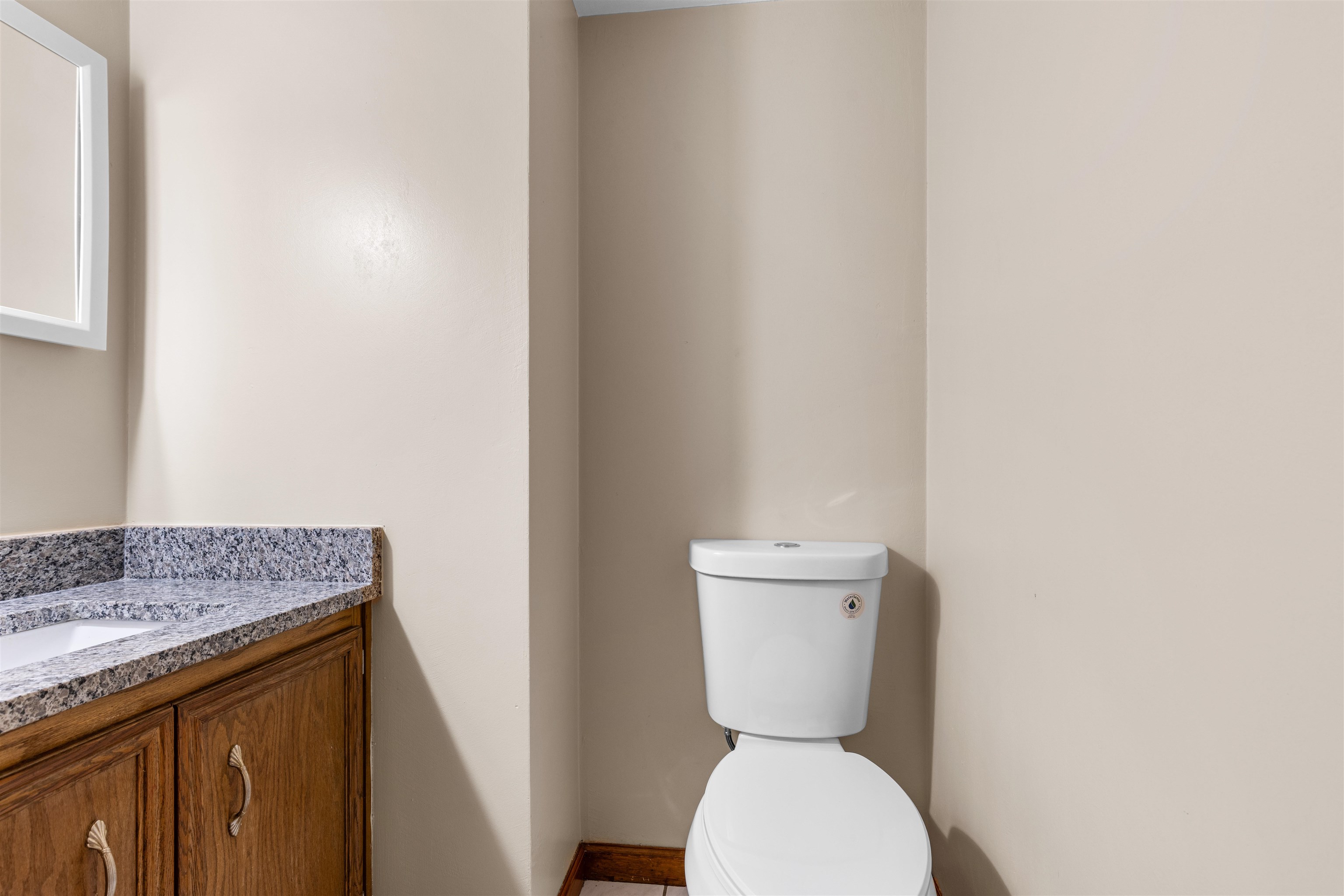 11738 Southgate Road Roscoe, IL 61073 - Photo 21 of 27 a bathroom with a granite countertop toilet and a sink