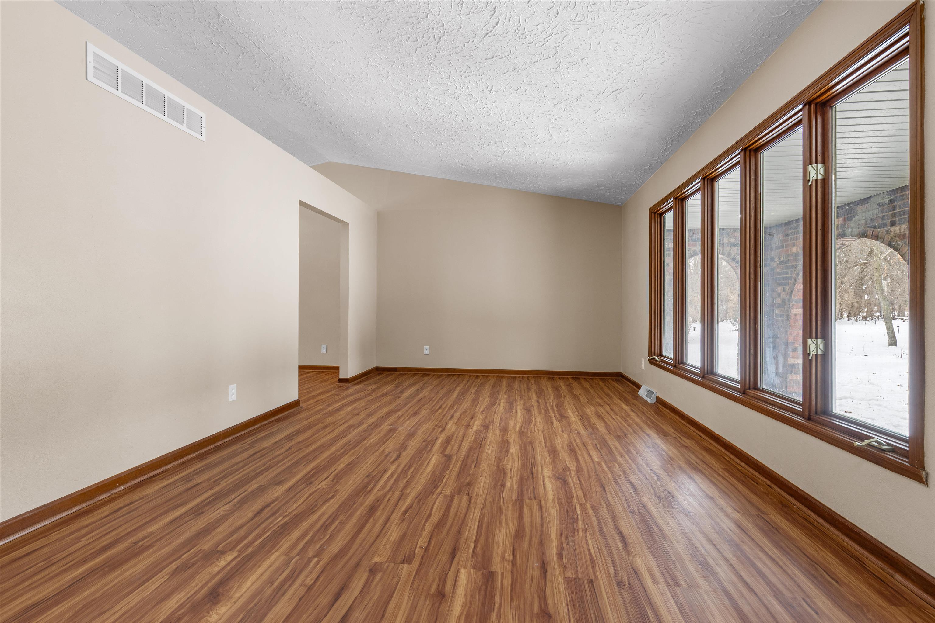 11738 Southgate Road Roscoe, IL 61073 - Photo 26 of 27 wooden floor in an empty room with a window