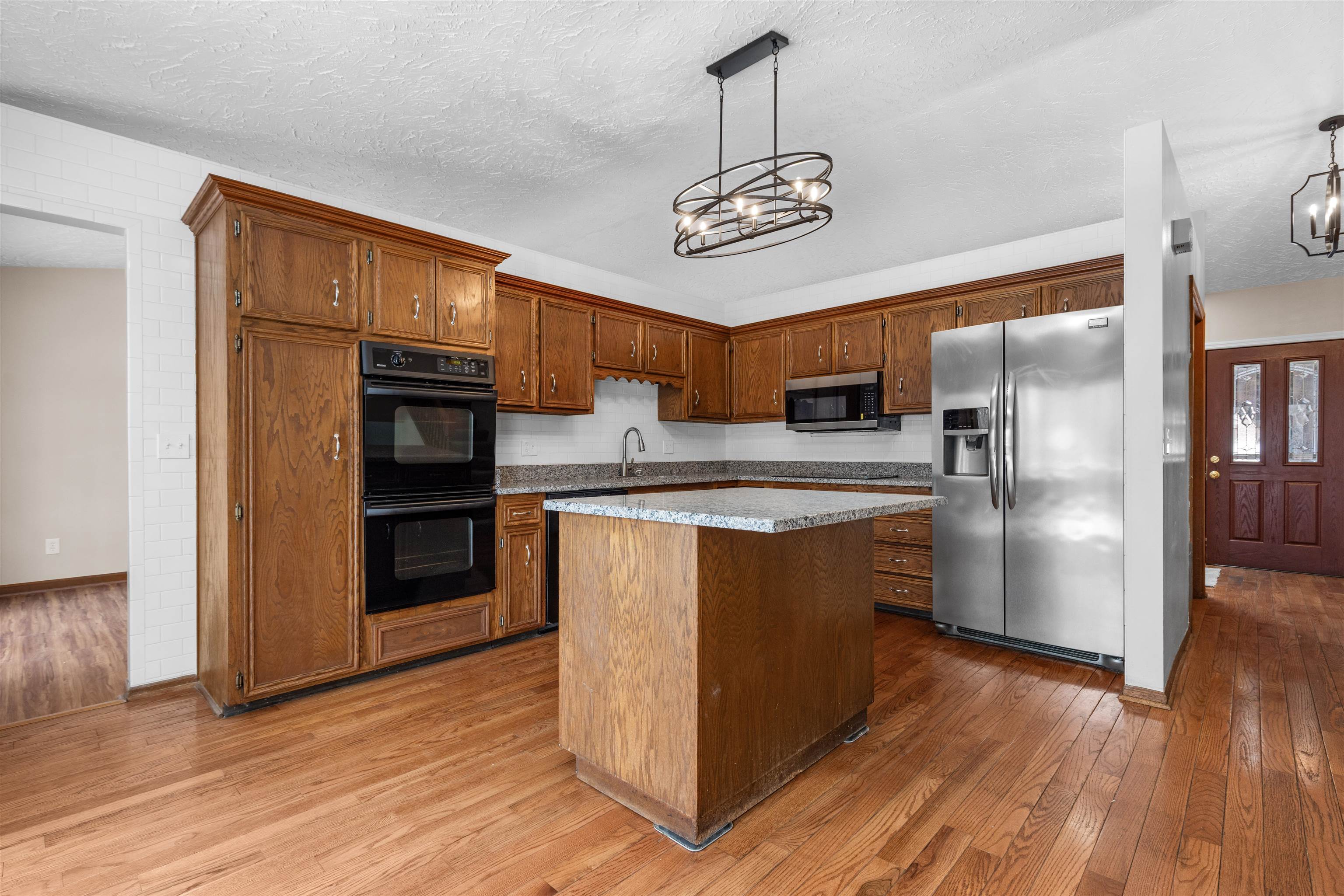 11738 Southgate Road Roscoe, IL 61073 - Photo 9 of 27 a kitchen with stainless steel appliances granite countertop a refrigerator and a stove top oven