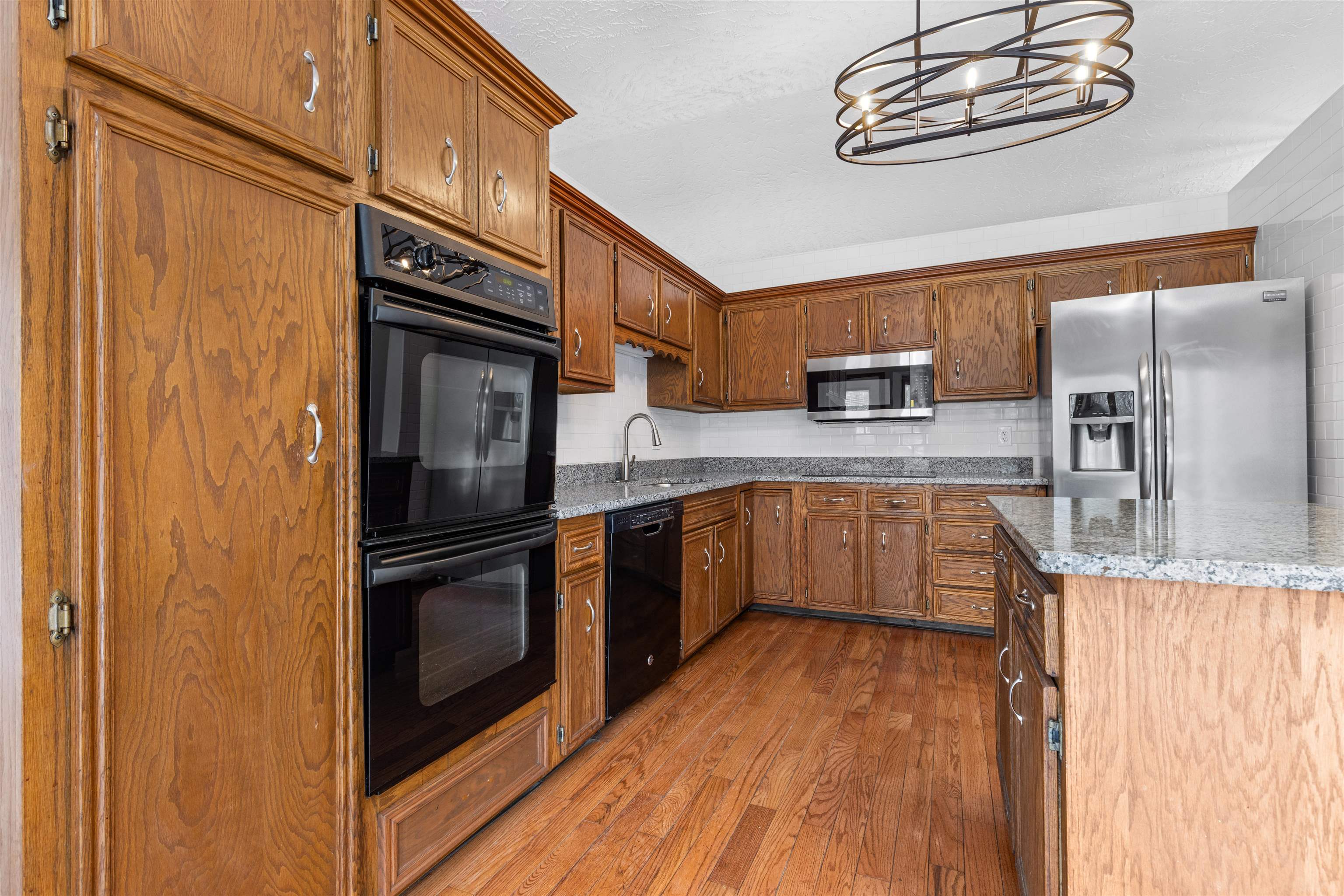 11738 Southgate Road Roscoe, IL 61073 - Photo 10 of 27 a kitchen with stainless steel appliances granite countertop a refrigerator and a stove top oven
