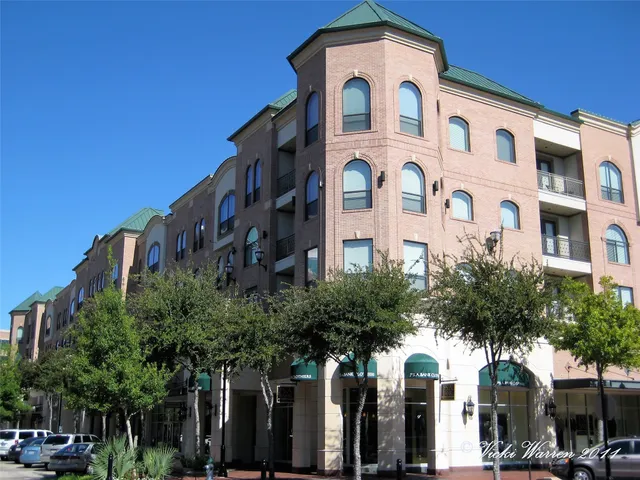 a front view of a residential apartment building with a yard