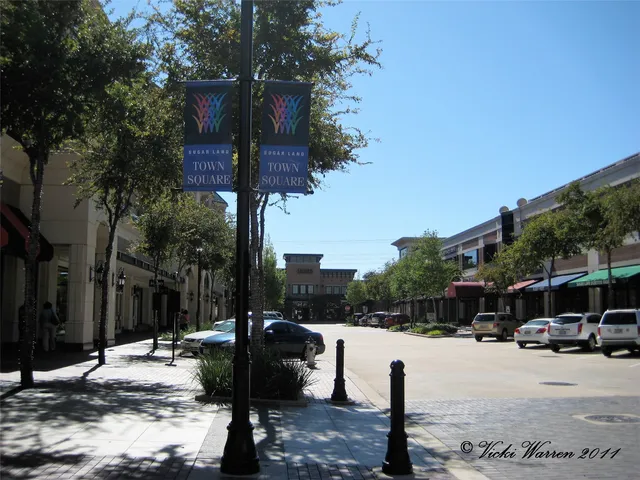 a street view with couple of cars parked on road