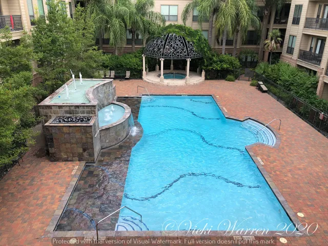 a view of a house with pool and chairs