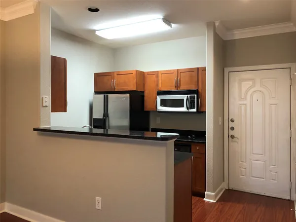 a kitchen with stainless steel appliances a refrigerator and microwave