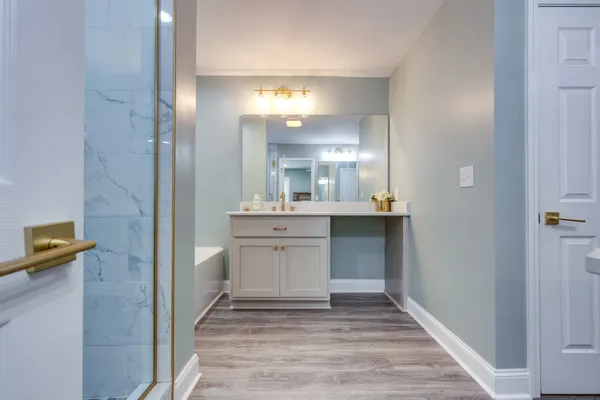 a bathroom with a granite countertop sink mirror and shower