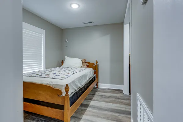 a bedroom with a bed and a chandelier