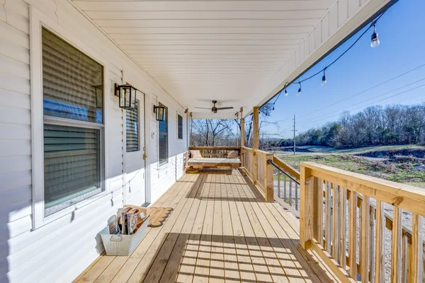 a balcony with furniture and wooden floor