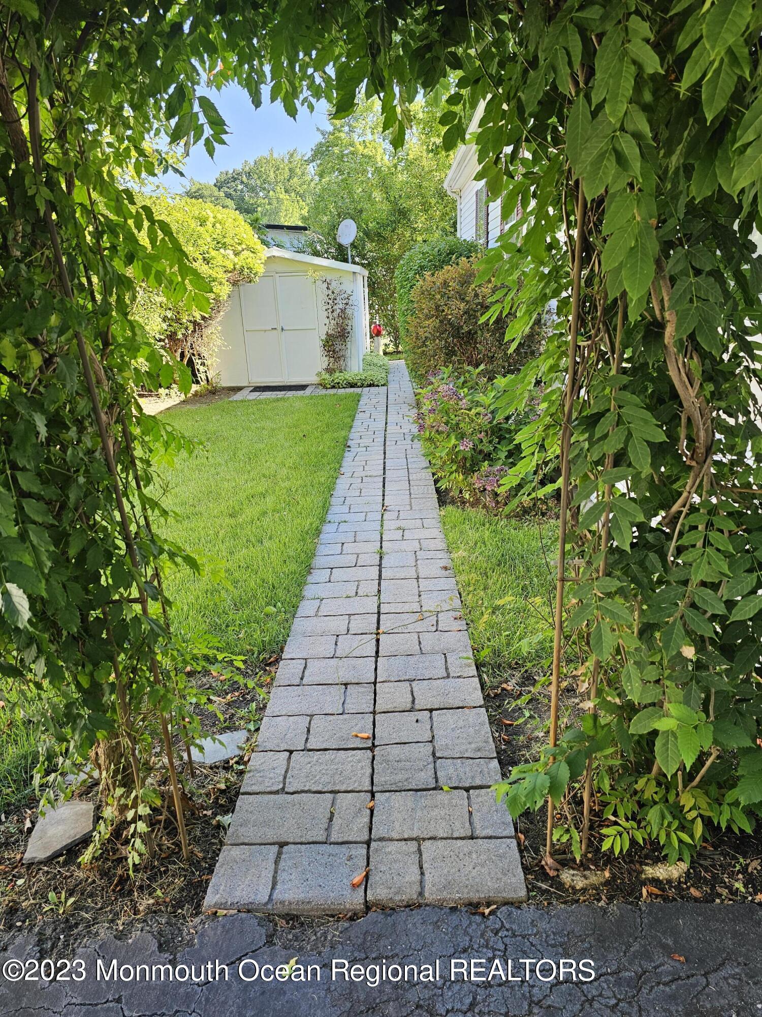 4 Village Road Morganville, NJ 07751 - Photo 6 of 34 a view of a pathway with a park