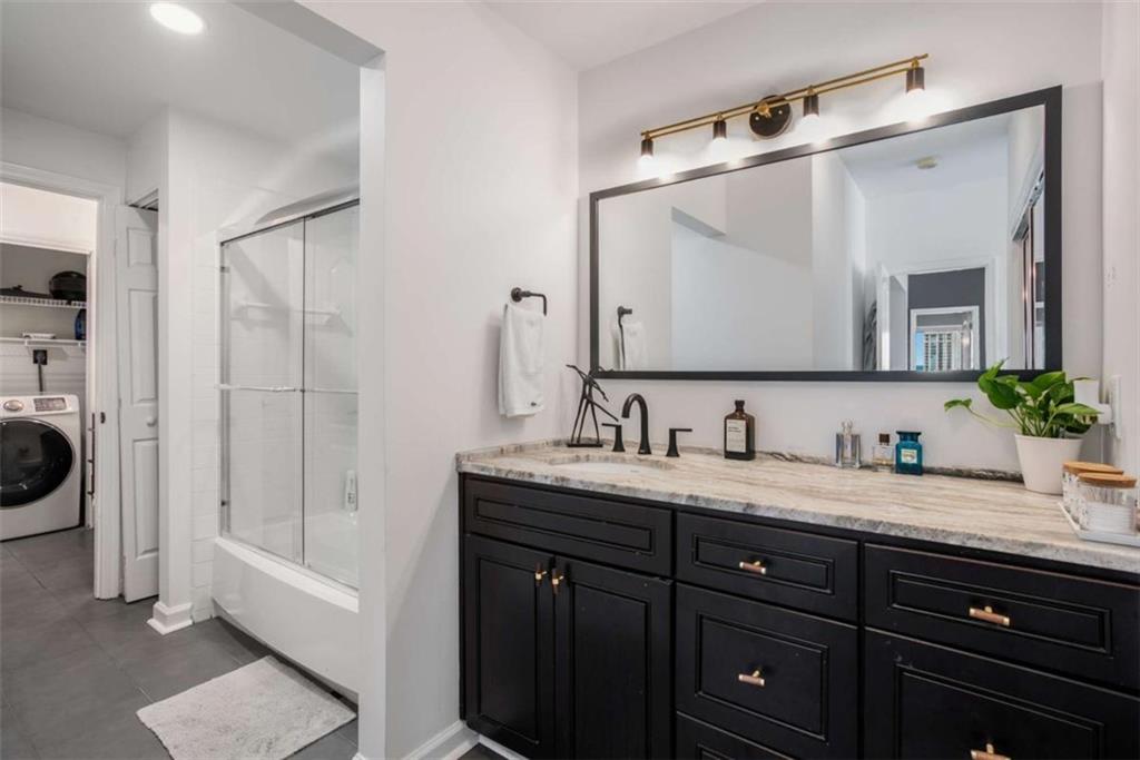 3475 Oak Valley Road Northeast, Unit 1630 Atlanta, GA 30326 - Photo 24 of 38 a bathroom with a granite countertop sink mirror and double