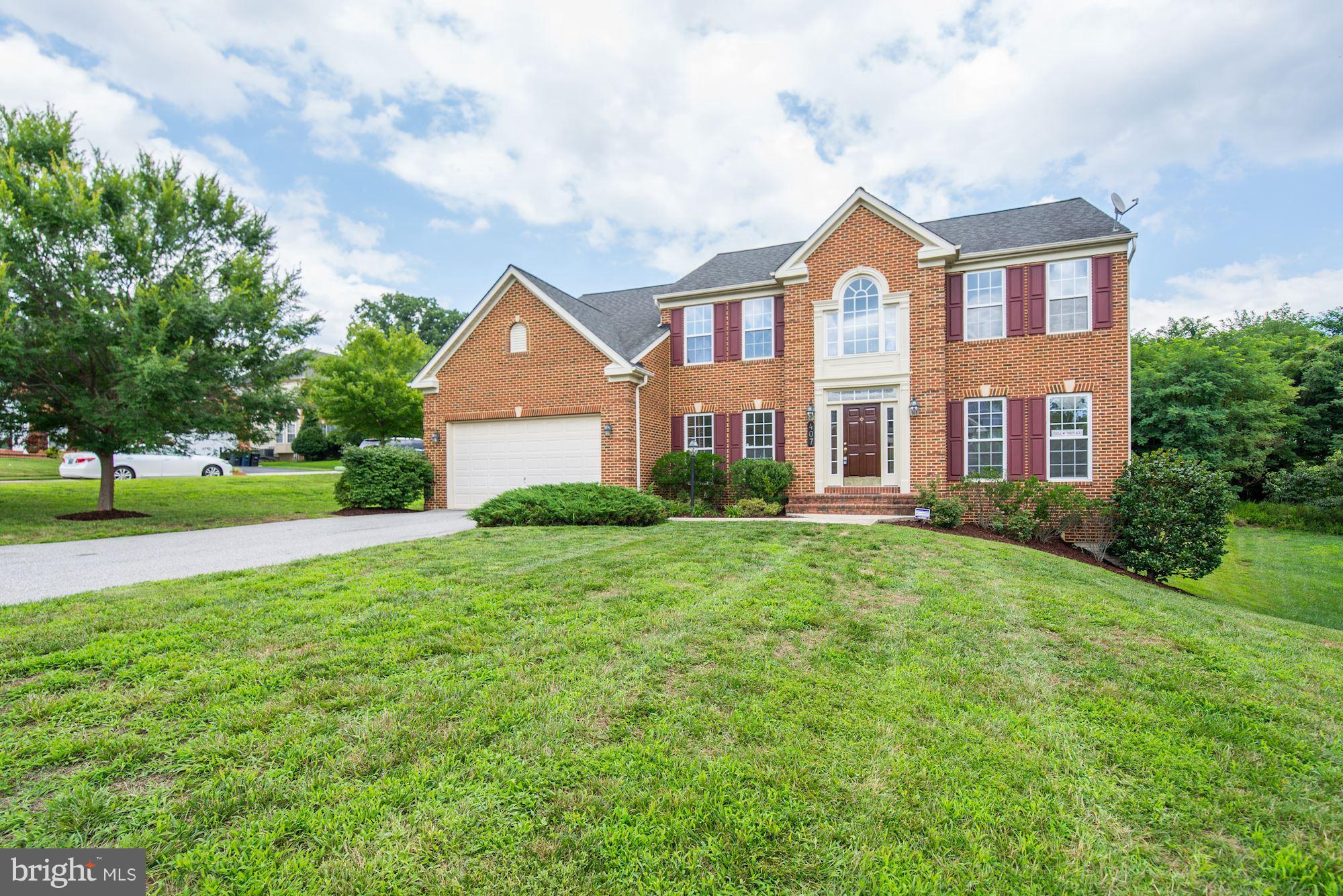 407 Potomac Ridge Drive Fort Washington, MD 20744 - Photo 2 of 30 a front view of a house with a yard and trees