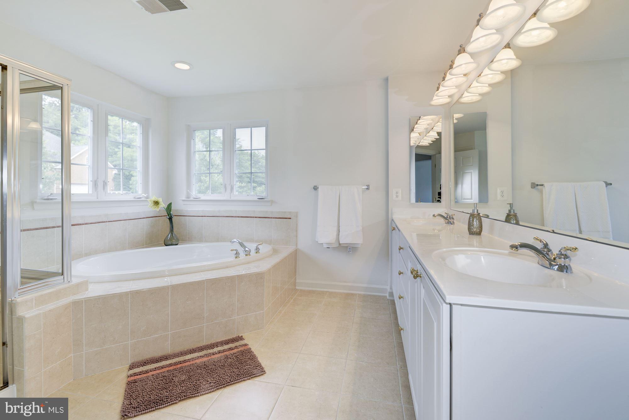 407 Potomac Ridge Drive Fort Washington, MD 20744 - Photo 16 of 30 a spacious bathroom with sinks mirror and a bathtub