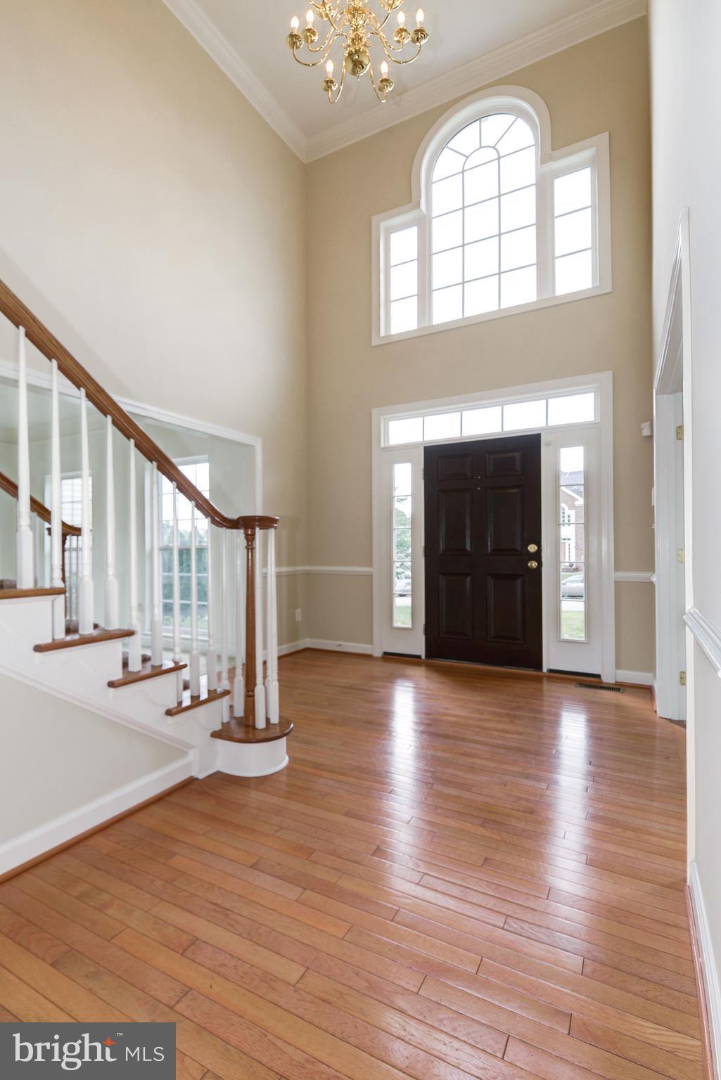 407 Potomac Ridge Drive Fort Washington, MD 20744 - Photo 3 of 30 an empty room with wooden floor fireplace and windows