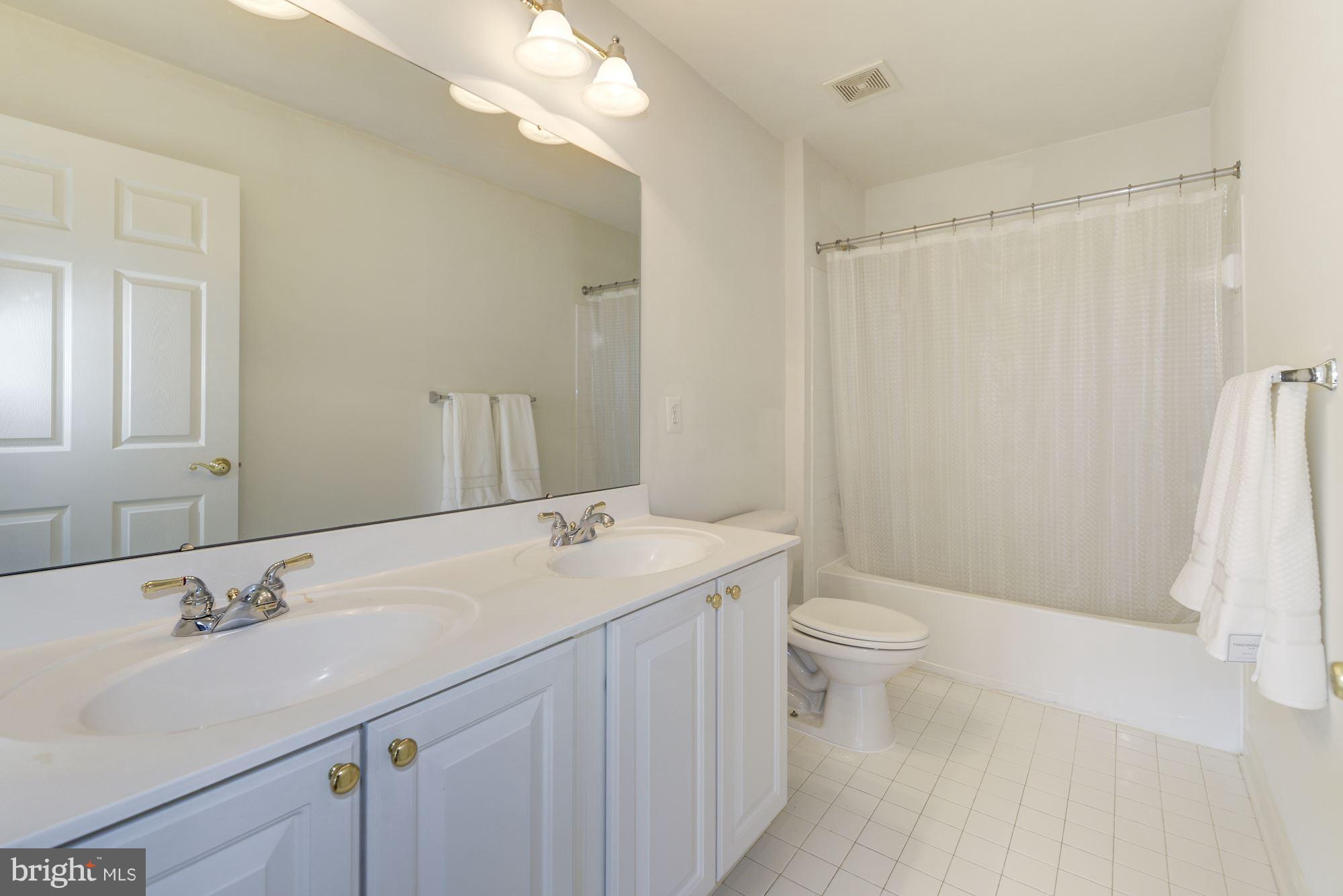 407 Potomac Ridge Drive Fort Washington, MD 20744 - Photo 21 of 30 a bathroom with a sink a toilet and shower