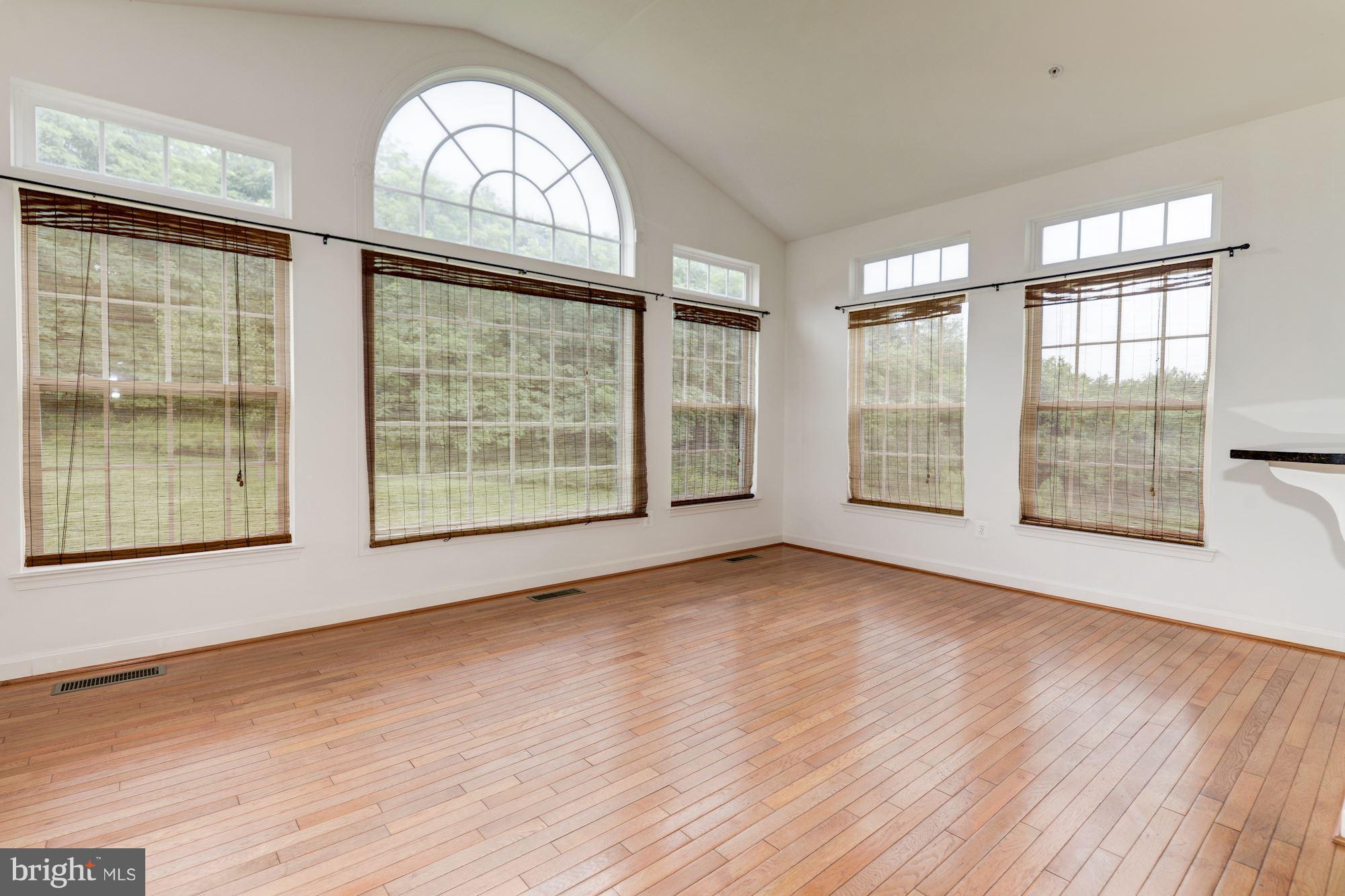 407 Potomac Ridge Drive Fort Washington, MD 20744 - Photo 8 of 30 an empty room with wooden floor and windows