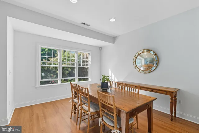 a dining room with furniture and a window