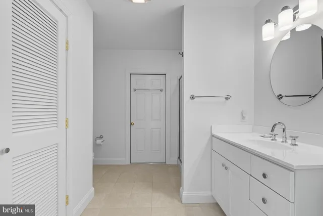a bathroom with a sink a light fixture and a mirror