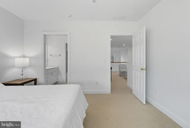 a bedroom with a bed and a lamp