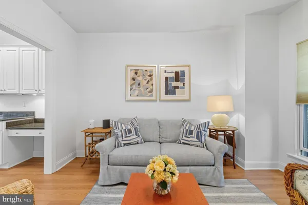 a living room with furniture and a lamp