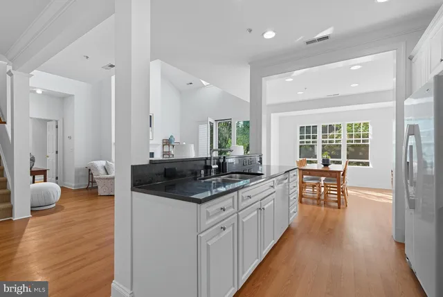 a large bathroom with a granite countertop sink and a large mirror
